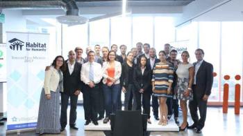 A group of participants stand in a group together.