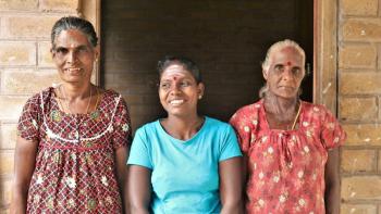 Homeowner Selvam (center) with her mother-in-law Vadivelu and her mother Anandamma at the door of her house in Sri Lanka