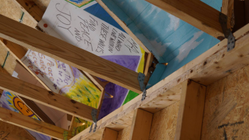 A photo of the underside of a roof with writing.
