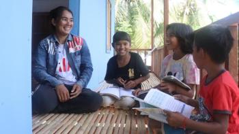 Phala, Chariya and their four children on their porch.