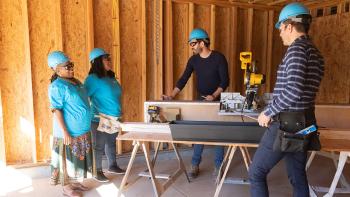 Drew and Jonathan Scott and Habitat homeowners build flower box made with Rockefeller Center Christmas tree lumber.