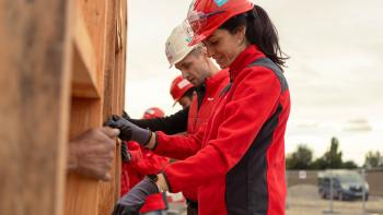 Volunteers working on wall from at construction site