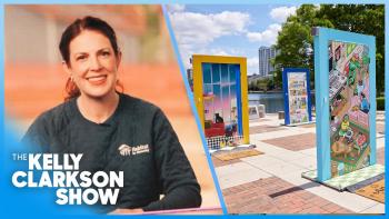 Image of Chief Communications Office Amy Dunham with a photo of a pop-up door installation. Beneath her it says The Kelly Clarkson Show.