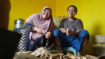 Tasnih and husband peeling cassava for home-based business in Batam, Indonesia