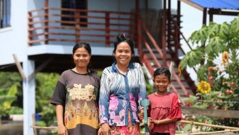 Rem and her granddaughters, Savy and Sarin, in front of their home in Battambang, Cambodia.