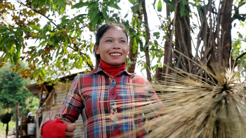 Lam makes a handcrafted broom at her house in Siem Reap