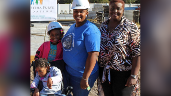 Alfie with her family on Habitat build site of their new home.