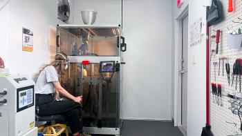 Margaret, Austin ReStore employee, operating the 3D printer. 