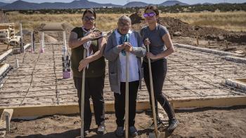 Luz with her daughter and granddaughter on build site with shovels.