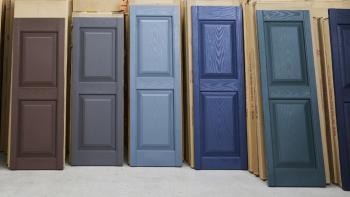 Row of painted shutters at Habitat ReStore.