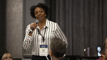 Woman with a microphone at an advocacy event. 
