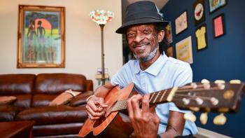  Michael Harris plays guitar in his home in the Musicians Village in the Upper Ninth Wa.rd