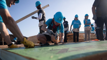 Volunteers building a house.