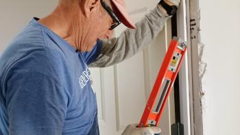 Man measuring door.