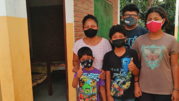 Bolivian family of five in front of their home