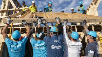 CWP volunteers lifting wood framing.