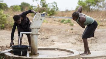 Zambian women pumping water from a well