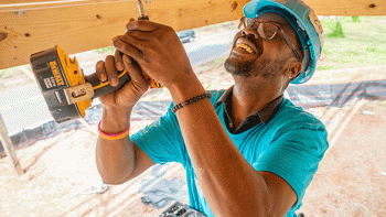 Habitat volunteer building at Home is the Key build day with O-Cedar and At Home