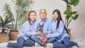Korean homeowner Jungbae (center) with wife (left), younger daughter (right) and dog
