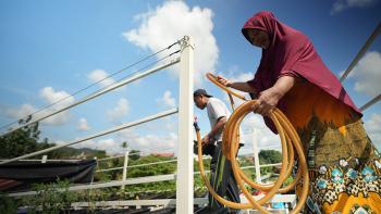Kartina and her husband Muhaeni at their rooftop garden, a passive cooling approach, in Batam, Indonesia