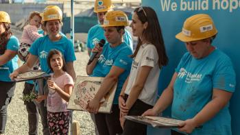Beneficiary speaking at the end of a Hope Build in Romania