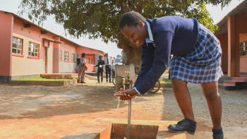 school girl washes her hands