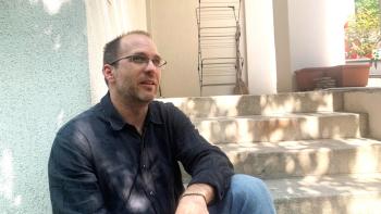 arpad sits in front of his apartment in Budapest