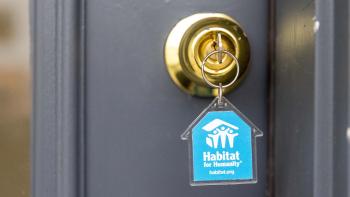 key in lock with blue Habitat keychain