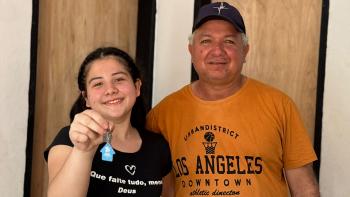 A man and his daughter inside a house