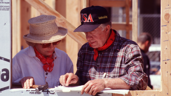 The Carters standing together on the build site.