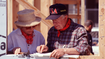 The Carters looking at plans together on the build site.