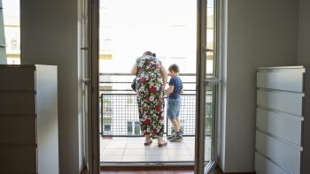 woman and child looking out on the balcony