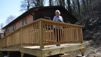 Homeowner stands on new wooden ramp