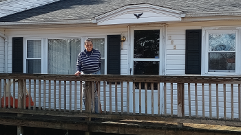 A homeowner on the front porch of her white house in Franklin County, Virginia.