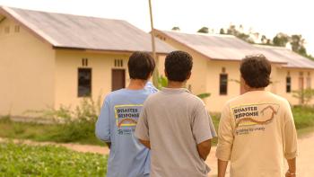 Habitat staff looking at houses under Indonesia tsunami response project