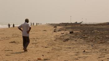 People walking on the beach in southeastern India after 2004 tsunami hit