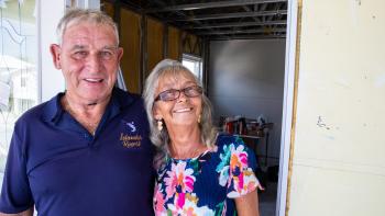 An older couple standing in the doorway.