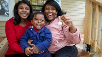 Jessica hugging her two children on their porch.