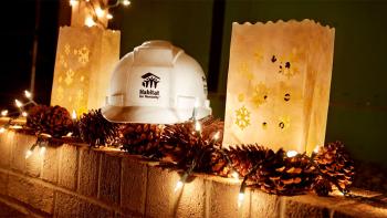 A mantel decorated with string lights and a Habitat hard hat