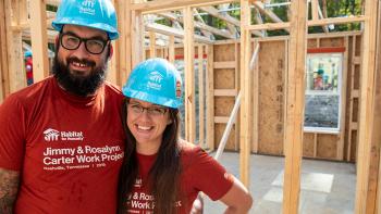 Neil and Erica in the build of their home, which is still lumber walls at the time of the photo.
