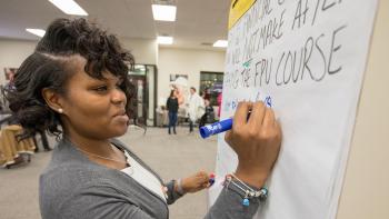 Woman writing on dry erase board