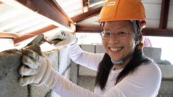 Woman in orange hardhat on a build site