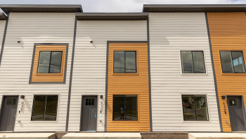 Row of modern yellow townhomes