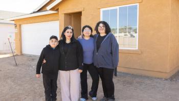 Family in front of house.