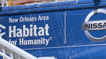 Blue van with "New Orleans Area Habitat for Humanity" and the Nissan logo on the side.