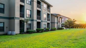 two-story apartment building and green lawn