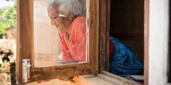 Habitat homeowner looking out of window, Nepal.