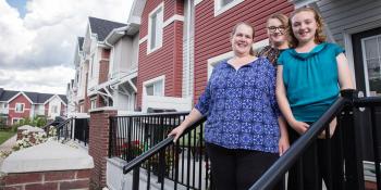 A family stands in front of their Habitat house.