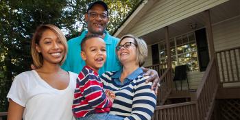 Homeowner family in front of their house