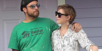 Matt and Valentina stand in front of their Habitat home.